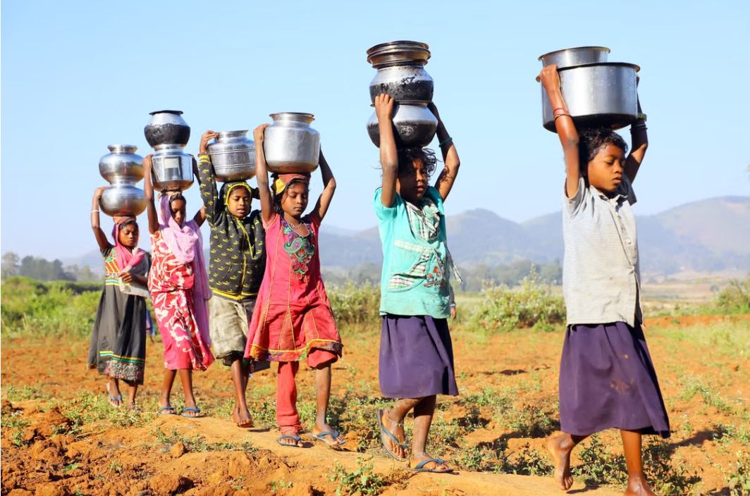 Children carrying water containers along a rural path